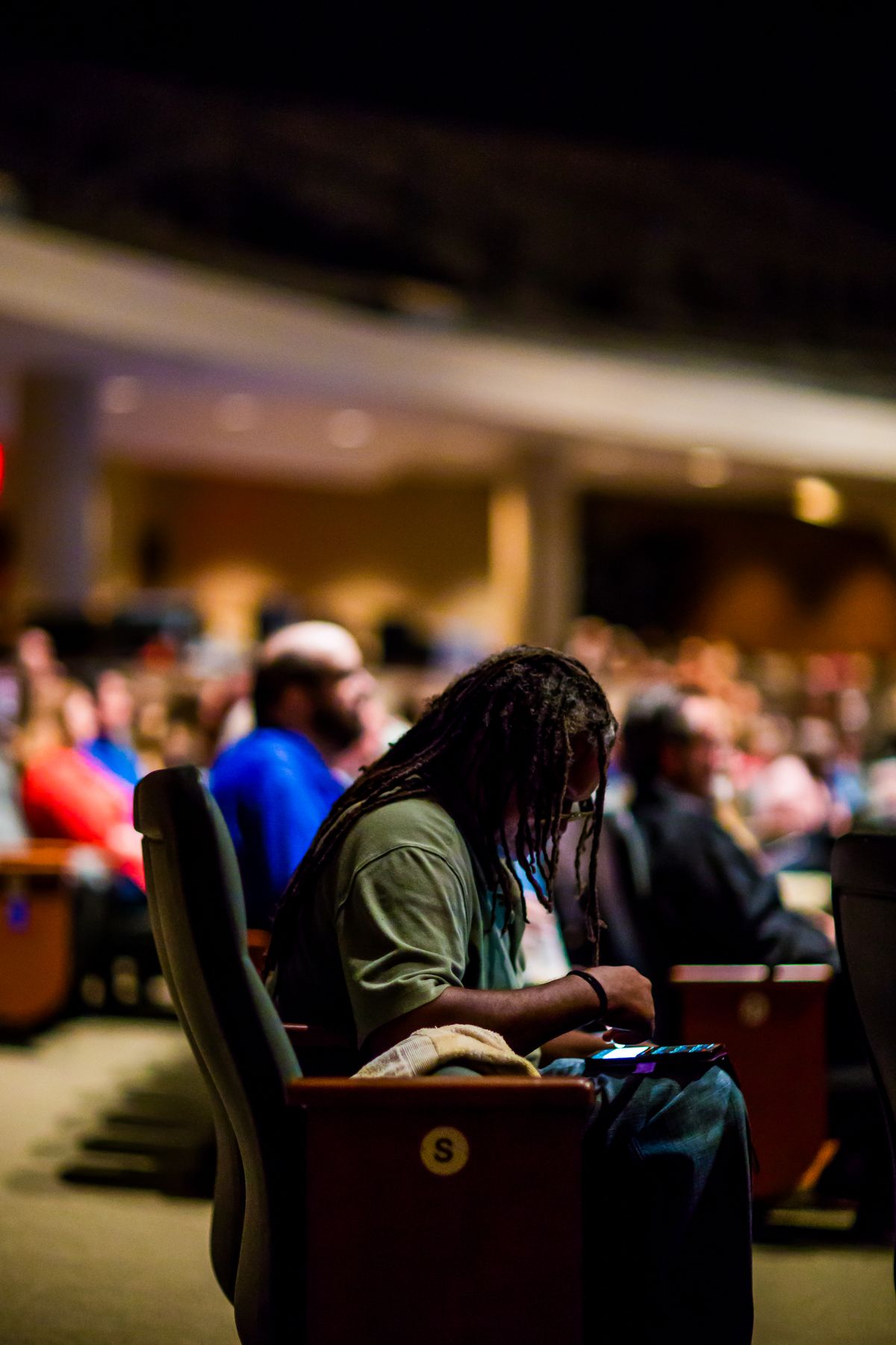 Attendees seated in a conference hall — illustrative service photography.