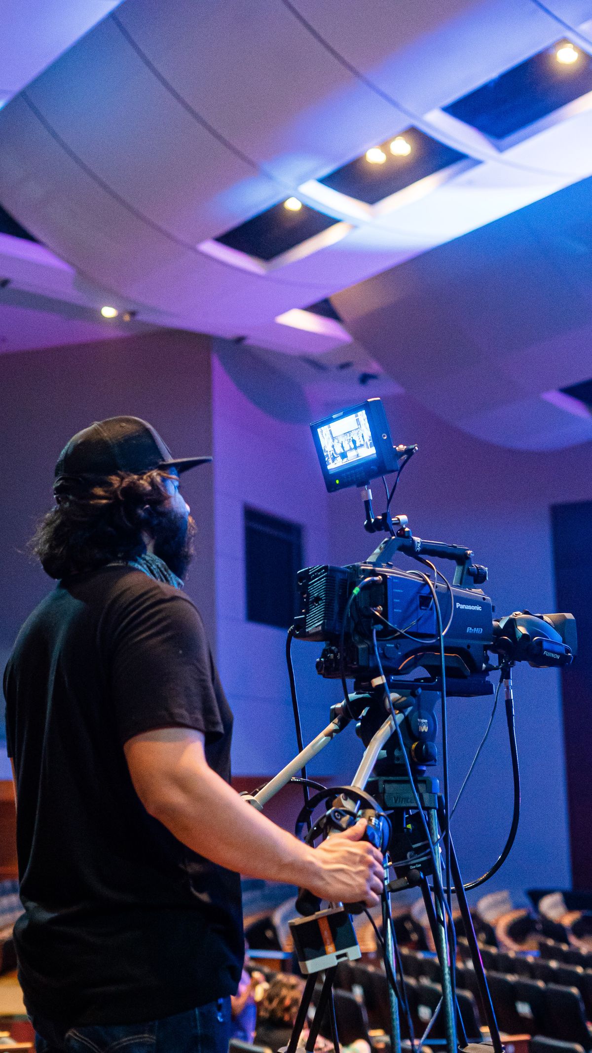 Videographer operating a professional camera at a live event — illustrative service photography.
