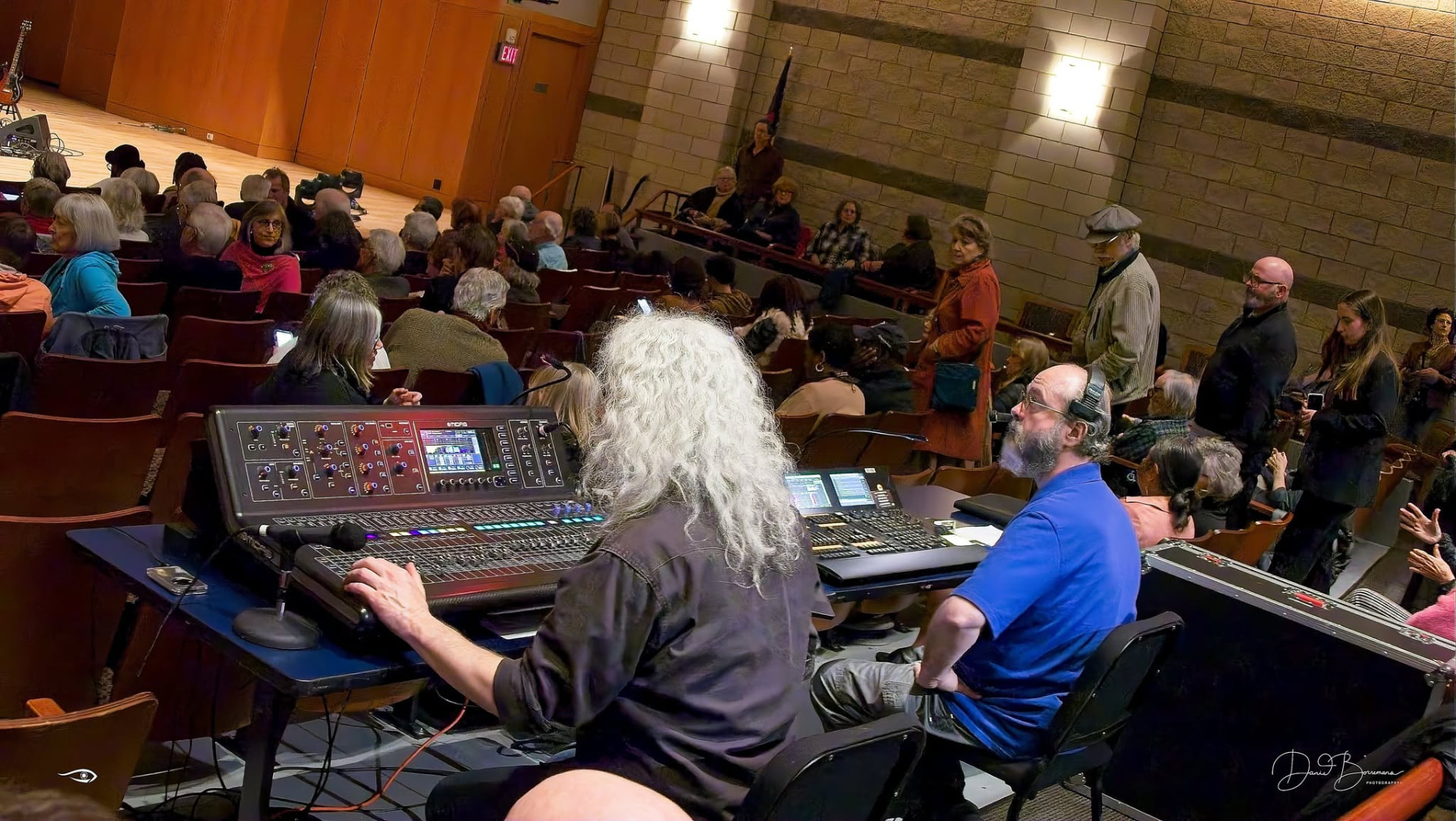 Front-of-house audio and lighting production booth operated during a live event.